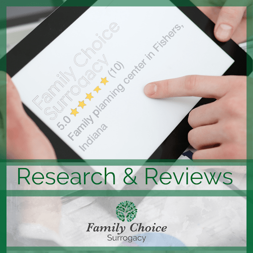 Doing research & reading reviews for a surrogacy agency (finger pointing to 5 stars) on a tablet. 